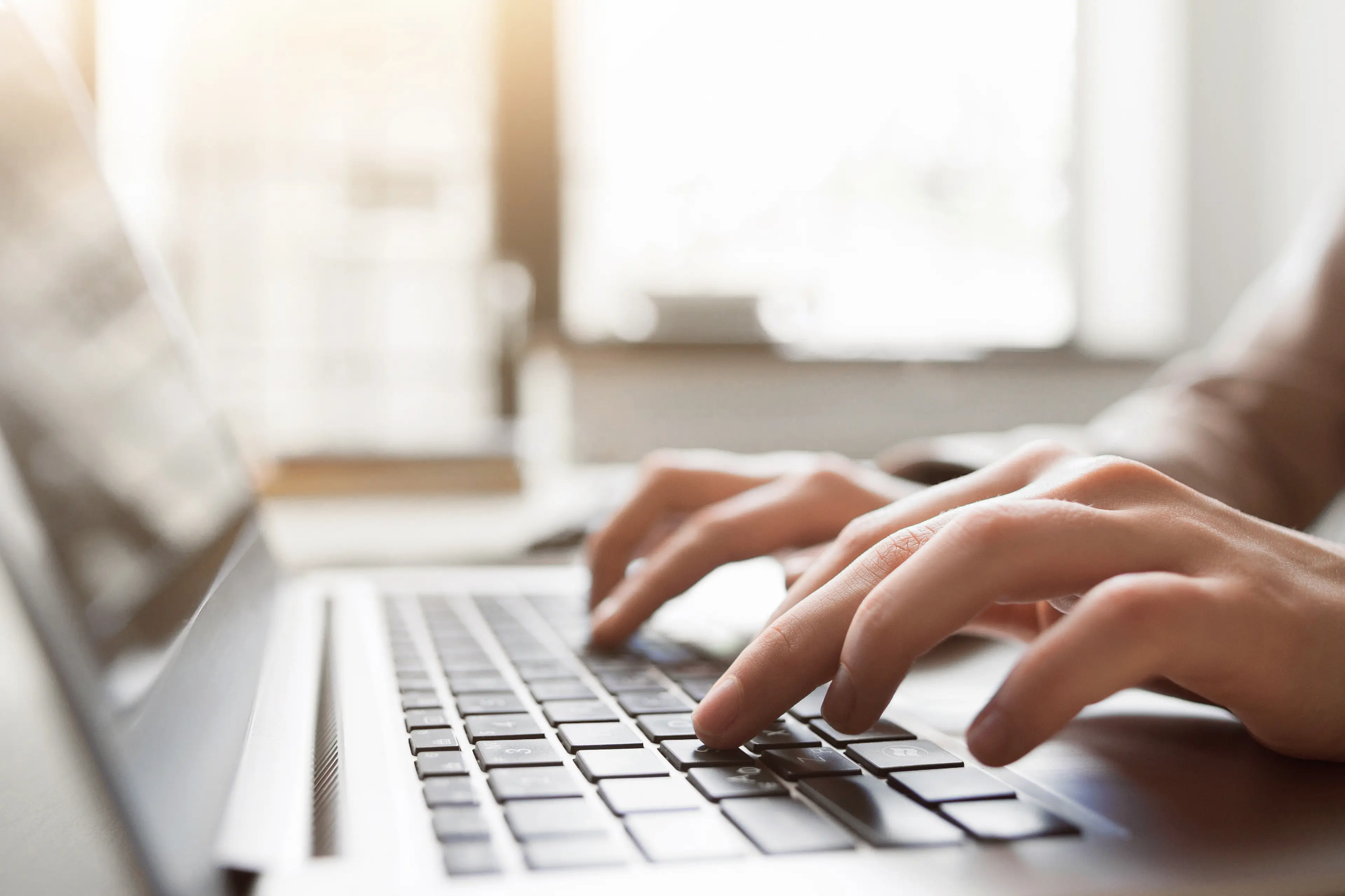A person typing on a keyboard